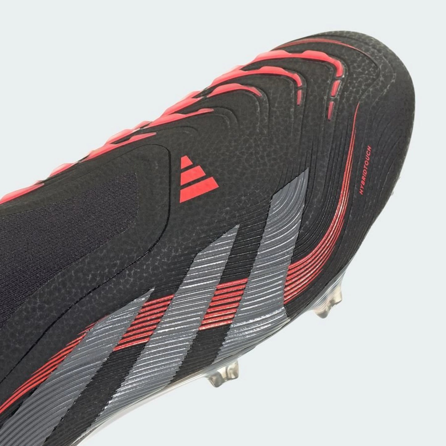close up view of the adidas Predator Elite Laceless FG "Stealth Victory" pack in a Black/Red/Grey colorway