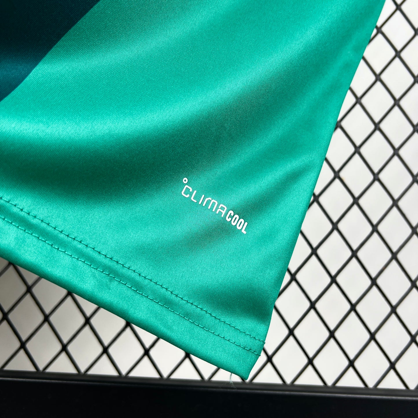 Adidas Northern Ireland 2026 Home Jersey fabric with 'Clima Cool' logo on a black and white grid background
