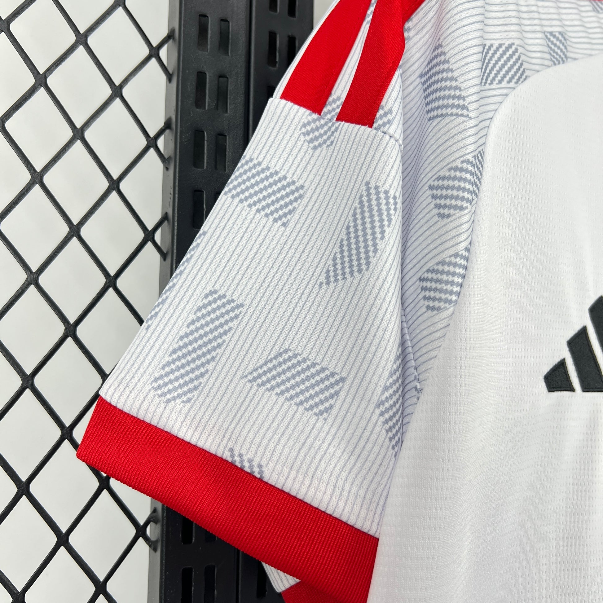 Adidas UAE 2026 World Cup Home White Jersey with red accents and Adidas logo on a black and white checkered background