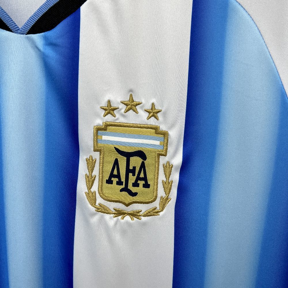 close up view of Argentina's logo on white and blue worldcup 2026 home jersey.