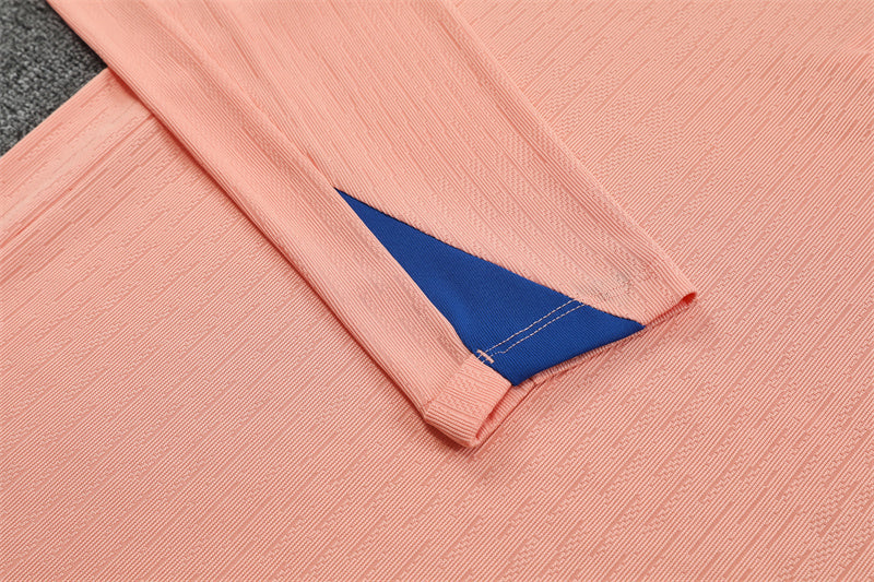 Sleeve of the pink quarter-zip top showing end sleeve details.