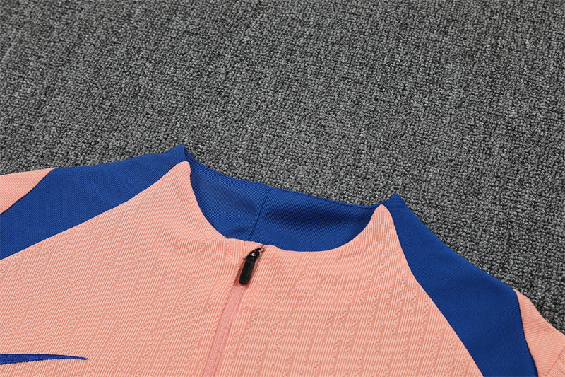 Close-up of the pink quarter-zip top showing zipper detail.