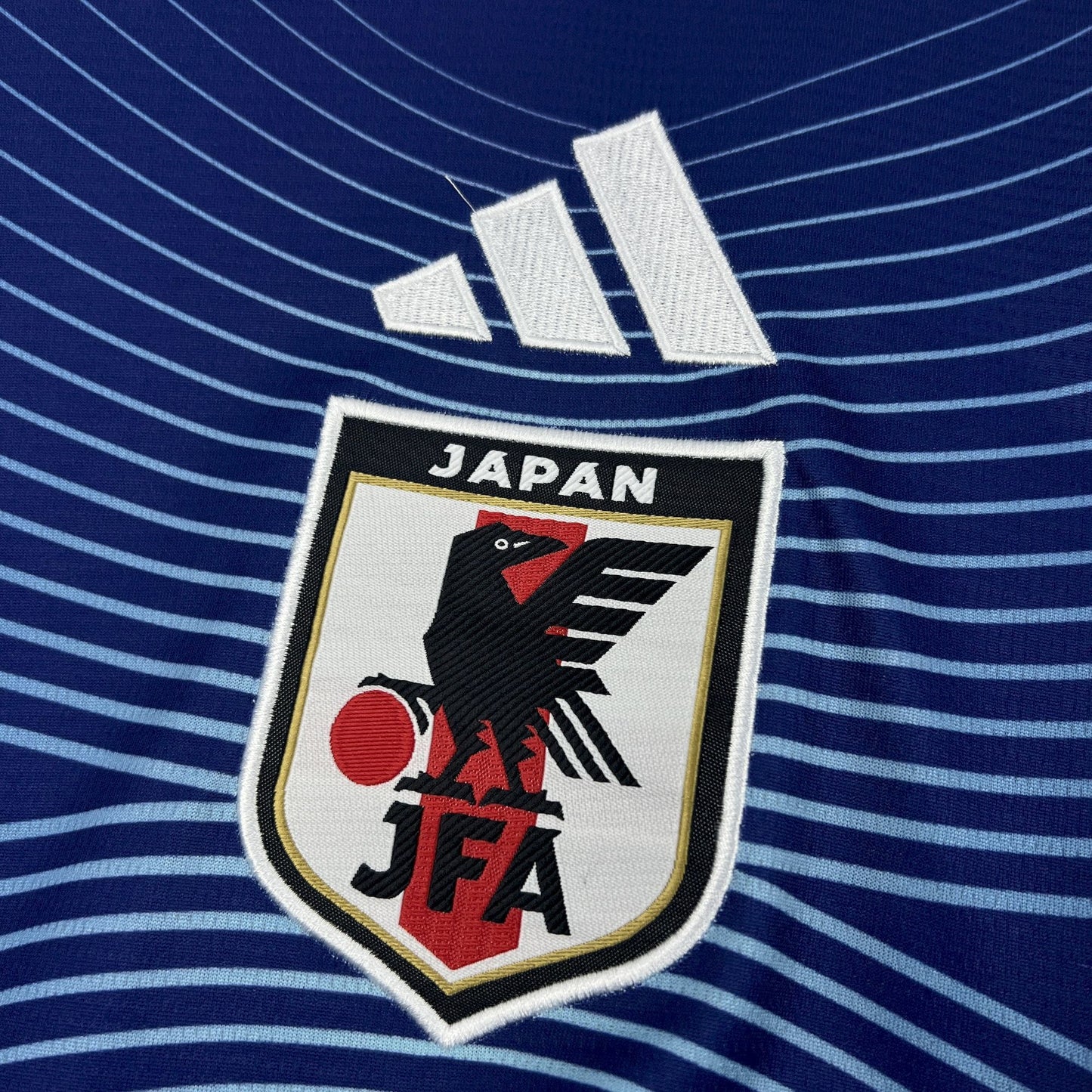 Japan 2026 Home Blue Jersey - Japanese logo on a blue striped Jersey.