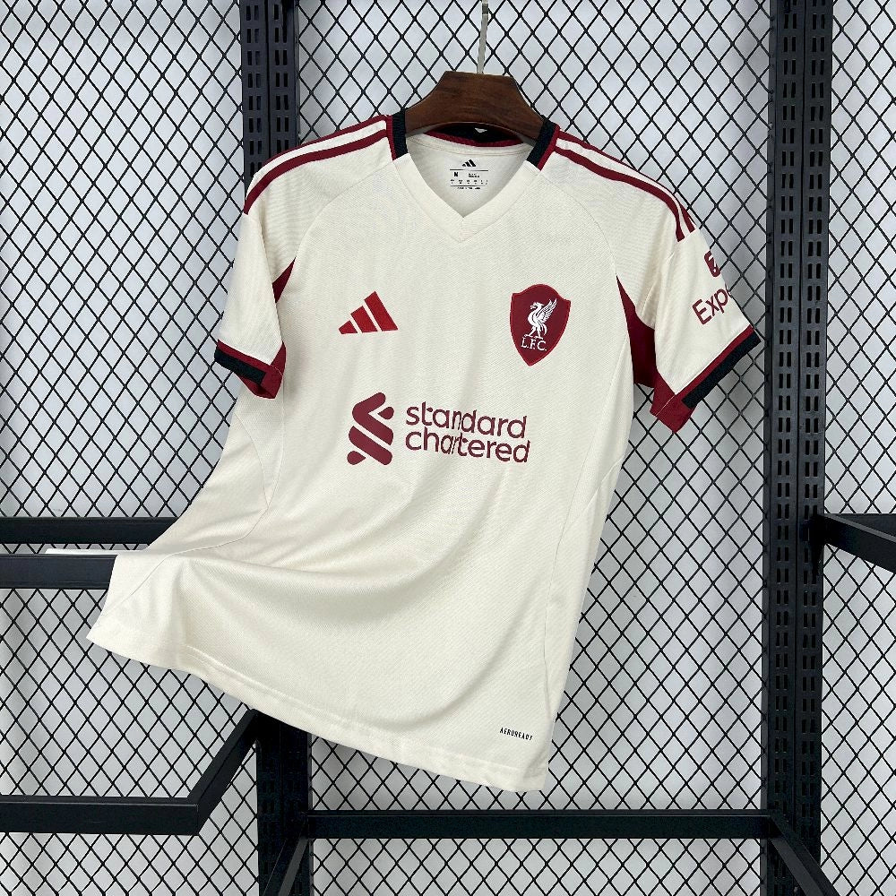 Front view of the Liverpool 25/26 Away Jersey, in Beige base and red accents