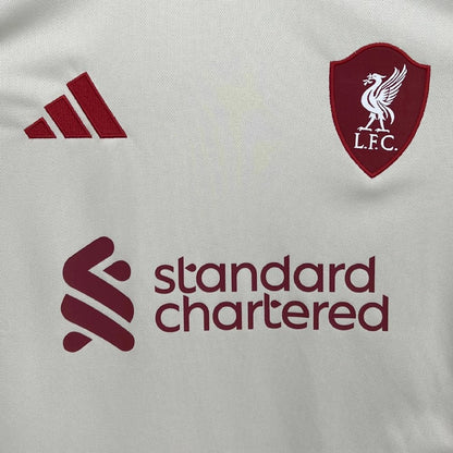 Close-up of Liverpool 25/26 away jersey with Adidas, Liverpool FC, and Standard Chartered logos.