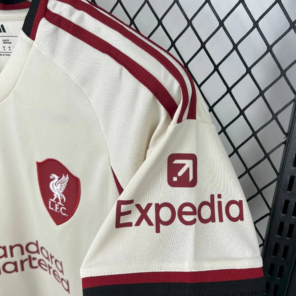 Shoulder view of the Liverpool 25/26 away jersey, showing the team and sponsor crests in red.
