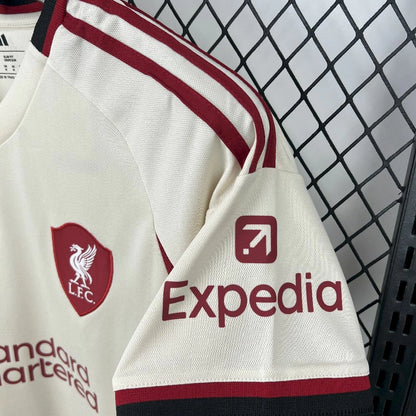 Shoulder view of the Liverpool 25/26 away jersey, showing the team and sponsor crests in red.