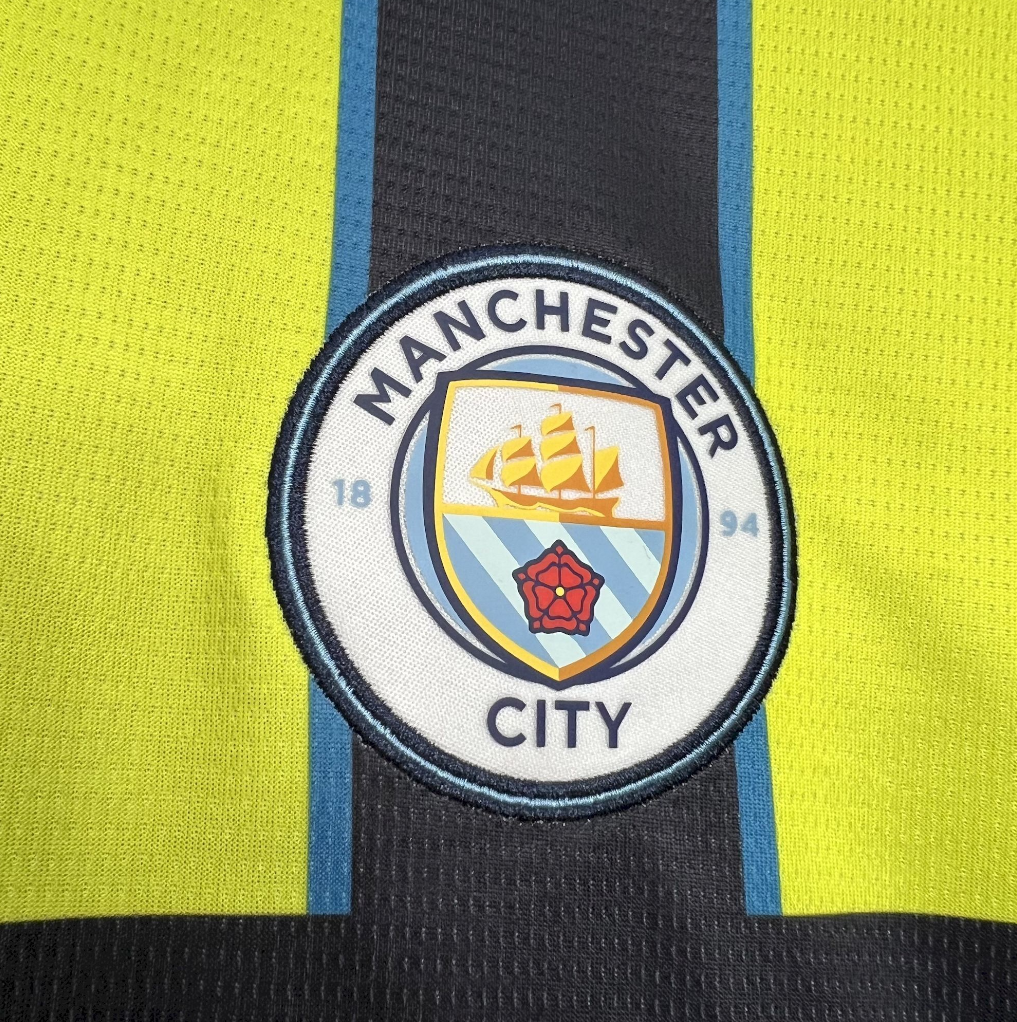 Manchester City logo on Manchester City 2024/2025 Away Puma Black & Yellow Jersey
