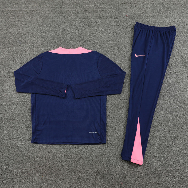 back view of the Nike Atletico Madrid 24/25 Navy Quarter Zip Tracksuit on grey ground.