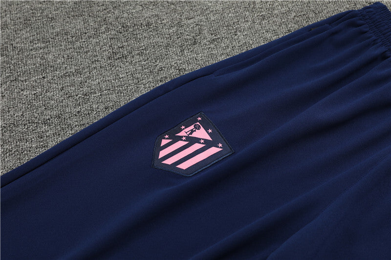 Close up view of the club logo on the pants of Nike Atletico Madrid 24/25 Navy Quarter Zip Tracksuit.