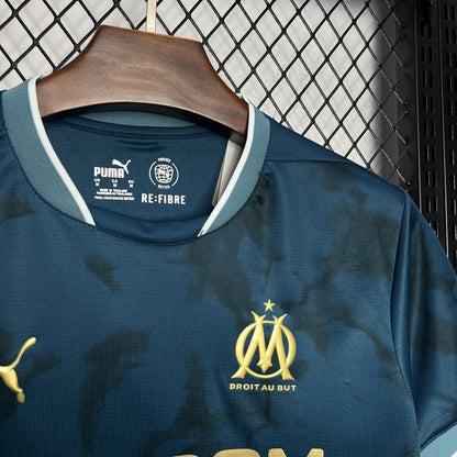 A close up view to the front of Olympique Marseille's 24/25 Away Blue Jersey.