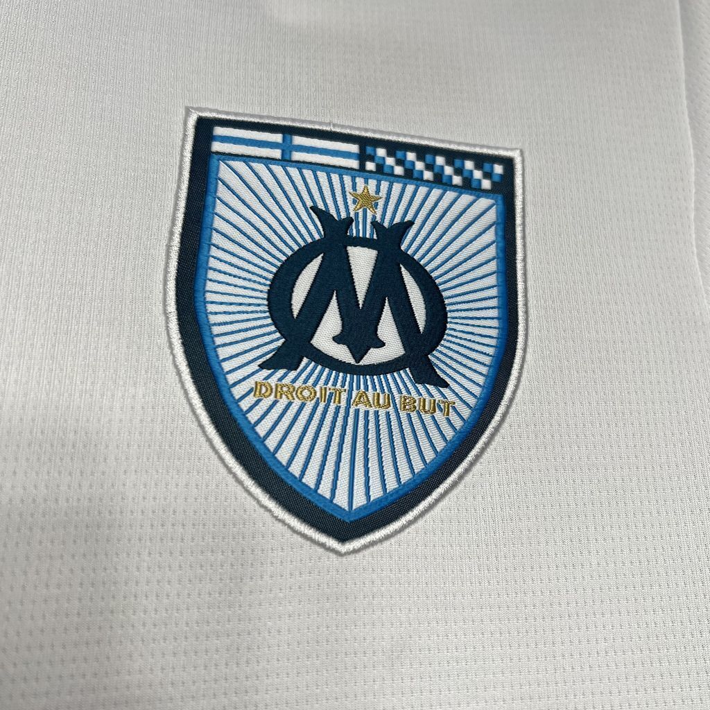Close up look at Marseille's logo in their 24/25 home white jersey.