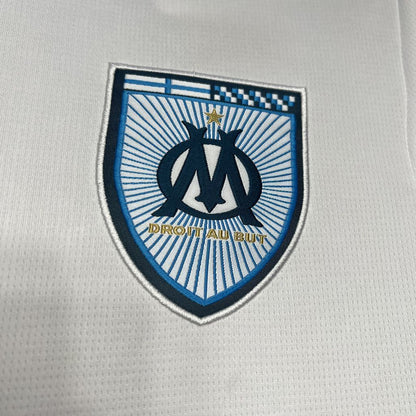 Close up look at Marseille's logo in their 24/25 home white jersey.
