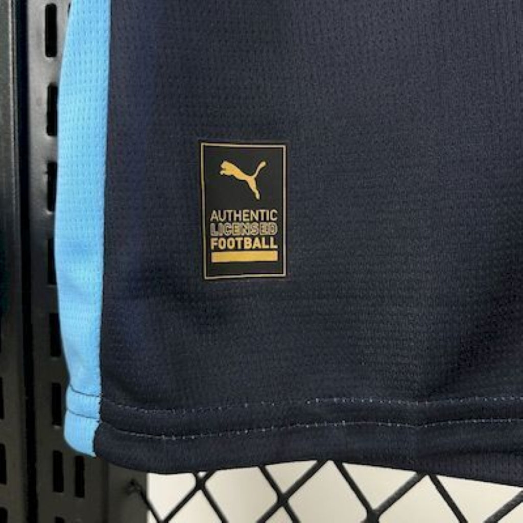 Navy blue Olympique Marseille 25/26 Away Blue sports jersey with a Puma logo and 'Authentic Licensed Football' tag.