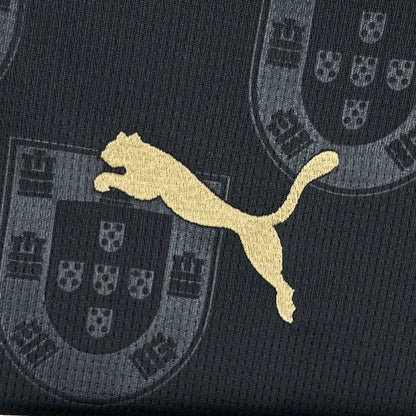 Portugal 2026 Away Jersey - Puma logo on a black fabric with Portuguese coat of arms pattern.