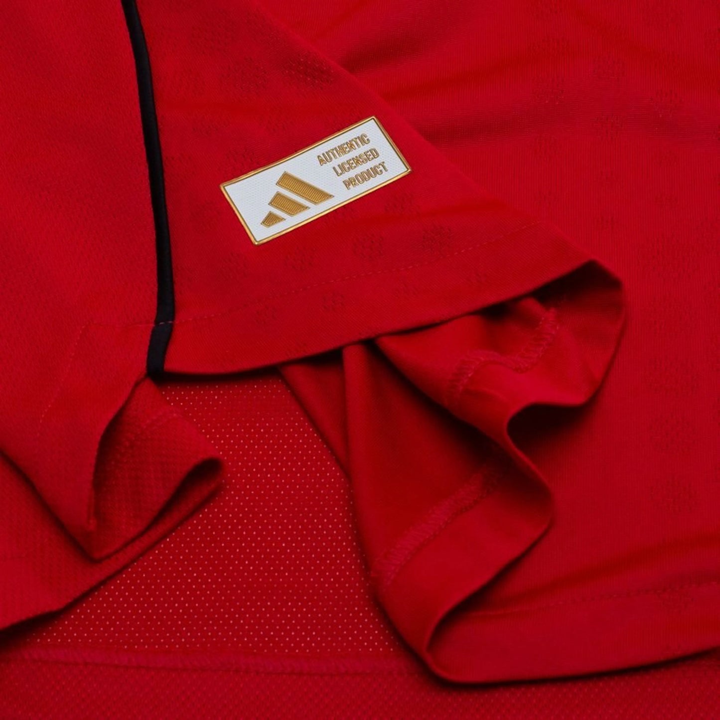 bottom left view on the adidas logo view on the Manchester United 2025/26 Home Red Jersey
