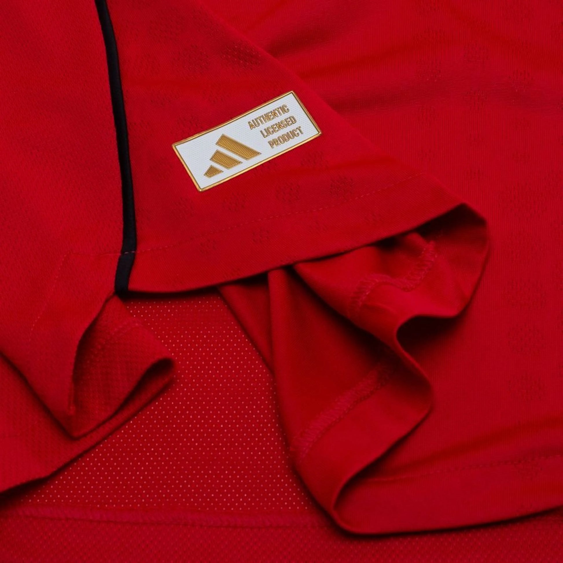 bottom left view on the adidas logo view on the Manchester United 2025/26 Home Red Jersey