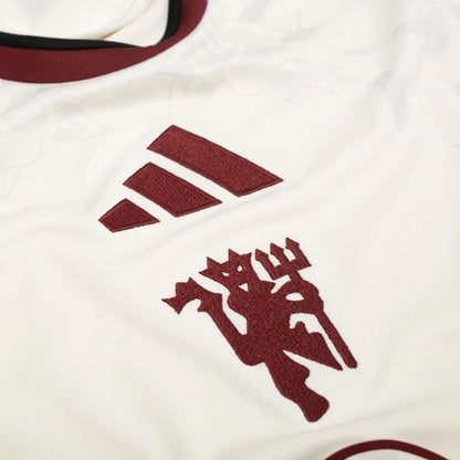 close up view of the adidas Originals Manchester United Womens Third Shirt 2026/27 Off White/Night Navy/Active Red