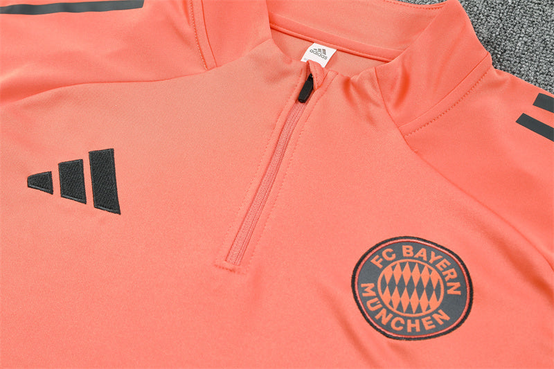 close view on the top of Bayern Munich 25/26 Quarter-Zip Tracksuit Orange top and grey pants