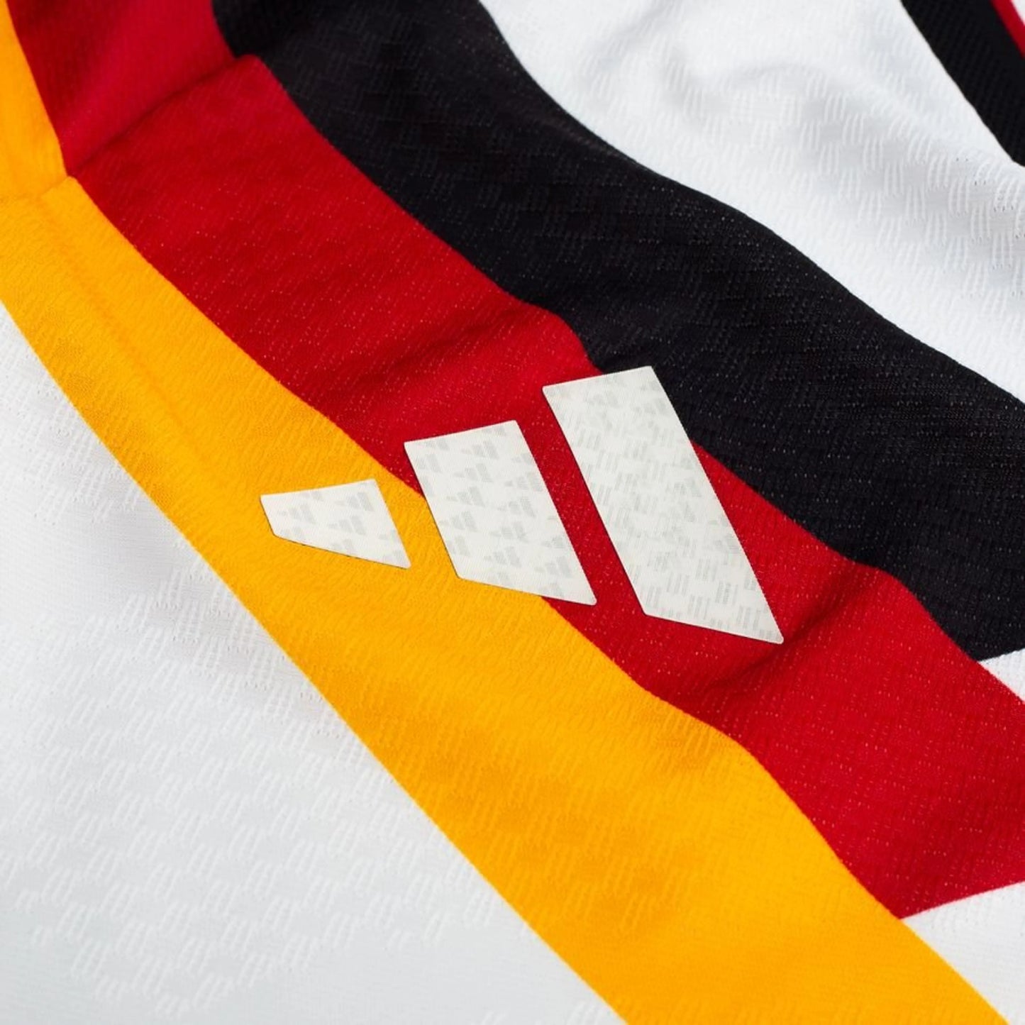 sponsor logo on the adidas Germany 2026 World Cup Home Authentic Long Sleeve Jersey in White Black Red Yellow