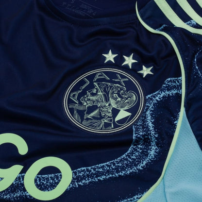 team logo view on the adidas Ajax 2025/26 Away Blue Shirt